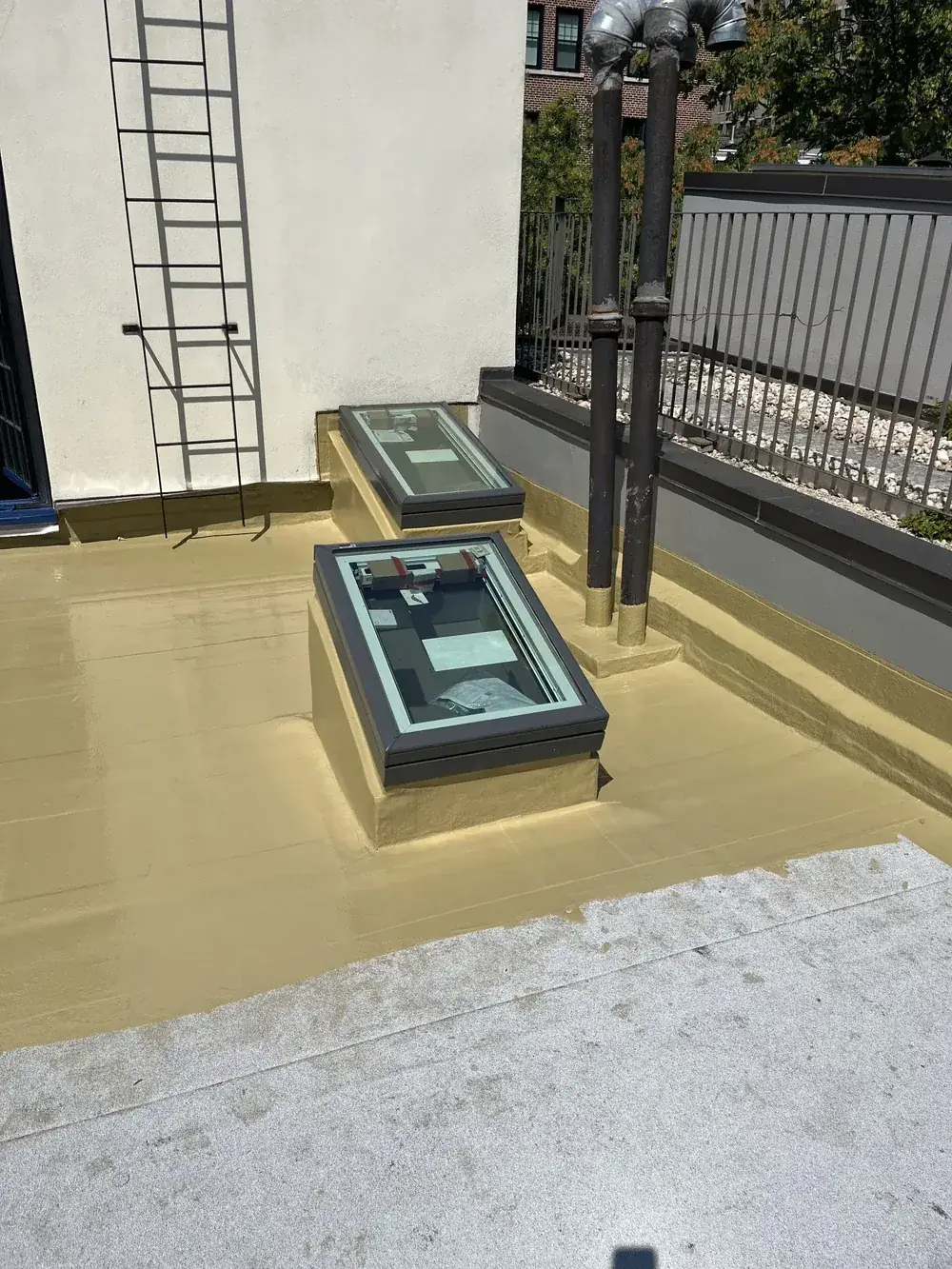 Completed roof coating and skylight flashing detail on an NYC building